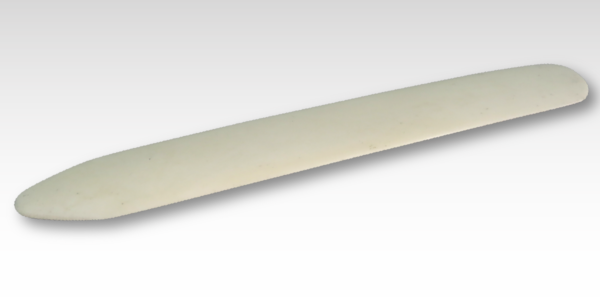 A custom rub on transfer of a white stone knife on a grey background.
