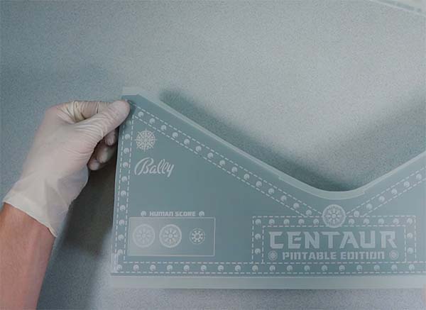 A person is holding a centaur rub-on transfer. A person is holding a centaur rub-on transfer.