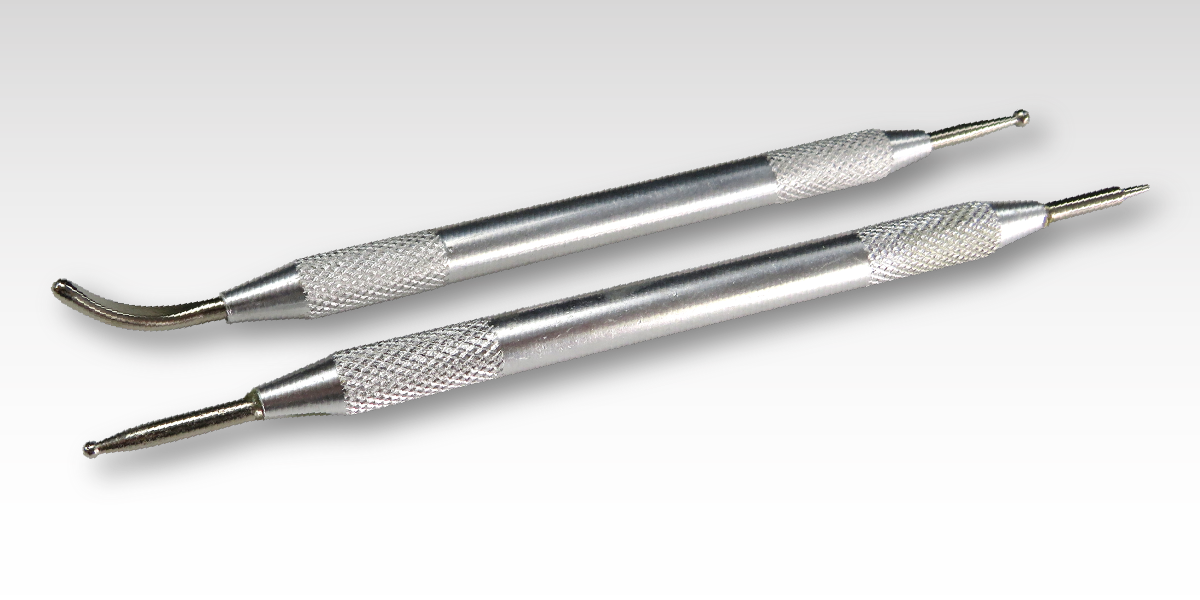 Two stainless steel tools with custom rub on transfer.