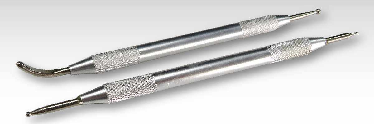 Stainless steel screwdrivers on a grey background with rub on transfers. Stainless steel screwdrivers on a grey background with rub on transfers.