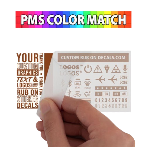 A hand holding a custom rub on transfer sticker.